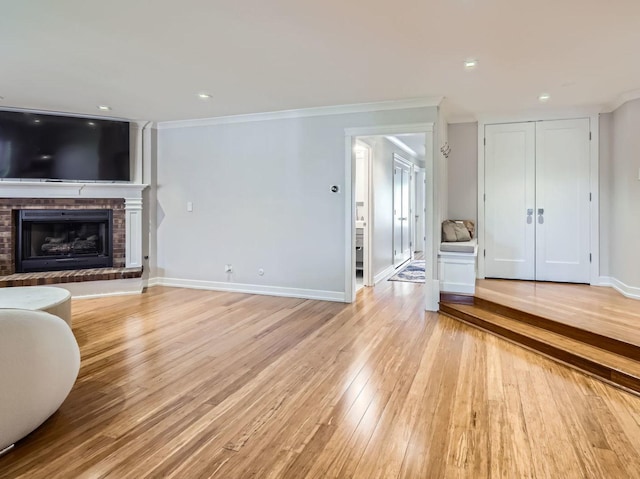 9748 Mill Dr E Unit 2E, Palos Park, IL 60464 - unfurnished living room with light wood-style floors, ornamental molding, a fireplace, and baseboards