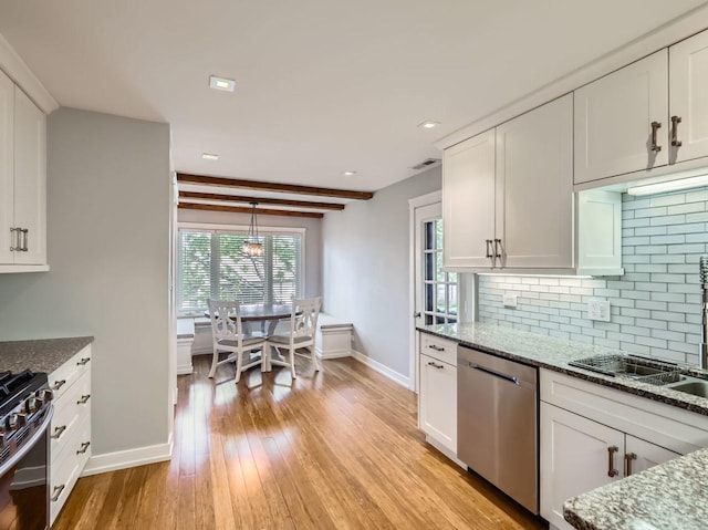 9748 Mill Dr E Unit 2E, Palos Park, IL 60464 - kitchen featuring stainless steel appliances, baseboards, decorative backsplash, light wood-style flooring, and white cabinets