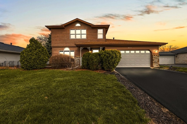 20113 Lake Lynwood Dr, Lynwood, IL 60411 - traditional home featuring asphalt driveway, a garage, brick siding, and a yard