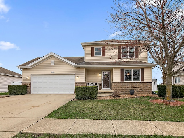 traditional-style house with brick siding, a front yard, driveway, and a garage