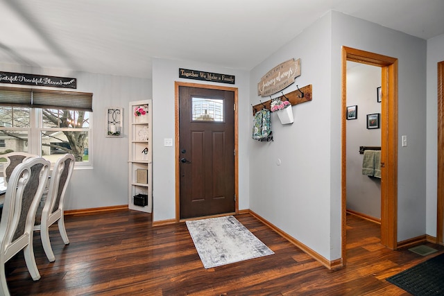 foyer with dark wood-style floors and baseboards
