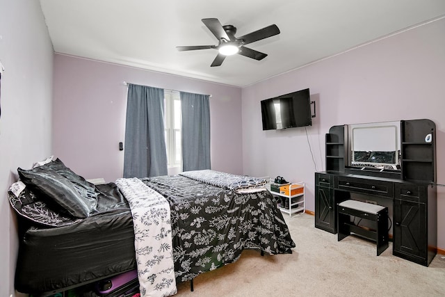 bedroom with ceiling fan, light carpet, and baseboards