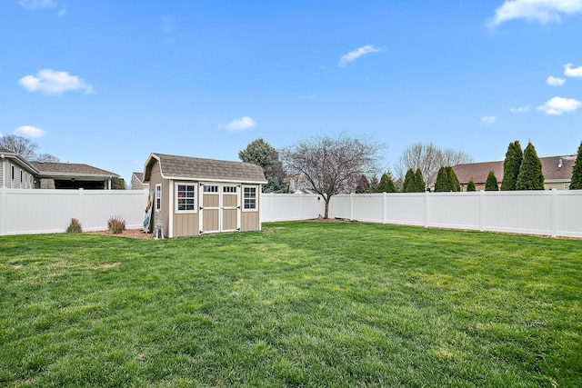 view of yard featuring an outbuilding, a fenced backyard, and a storage unit