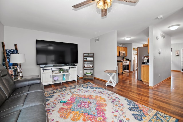 living area with dark wood-style floors, visible vents, baseboards, and ceiling fan