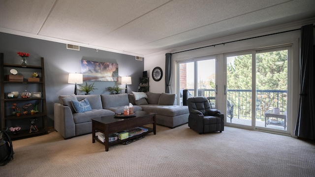 living area featuring visible vents, light carpet, and ornamental molding