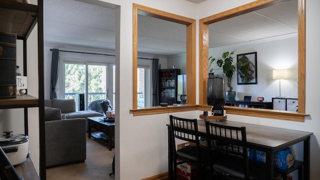 carpeted dining room featuring baseboards and ornamental molding