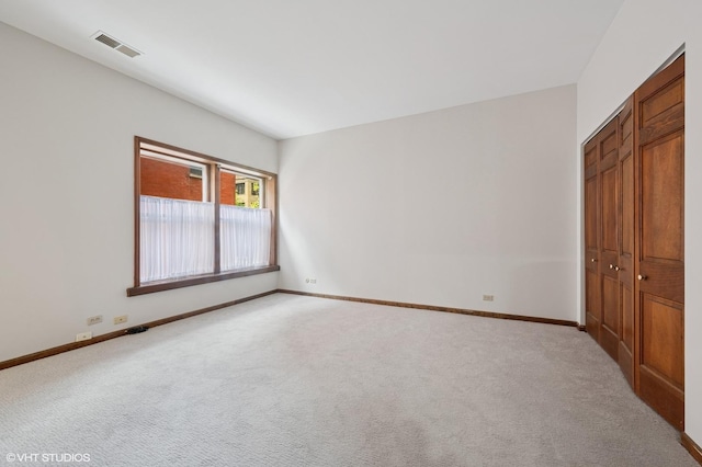 unfurnished bedroom with carpet floors, baseboards, and a closet