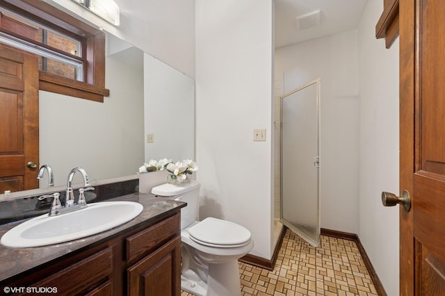 full bath featuring toilet, vanity, baseboards, a shower, and tile patterned floors