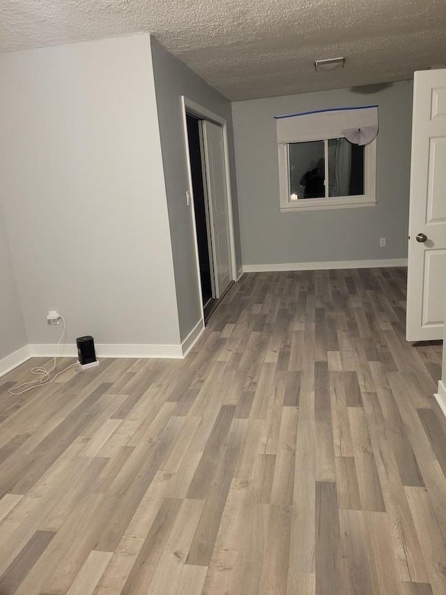 579 Price Ave, Calumet City, IL 60409 - spare room featuring wood finished floors, a textured ceiling, and baseboards