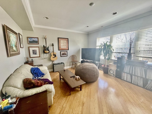 living room with baseboards, crown molding, and light wood-style floors