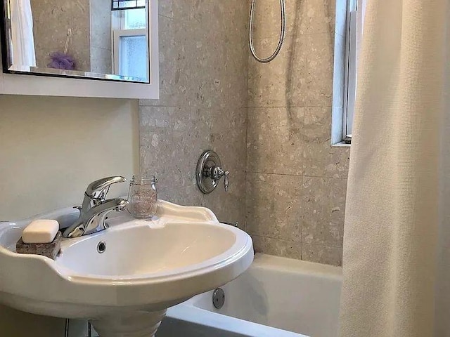full bath with shower / bath combo and a sink