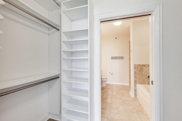 spacious closet featuring light tile patterned floors