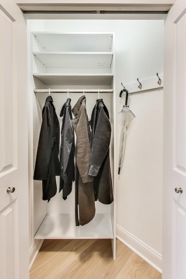 mudroom with light wood-style floors and baseboards