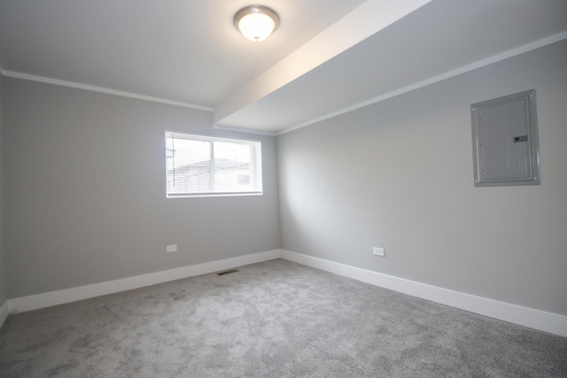 carpeted empty room with visible vents, baseboards, and electric panel
