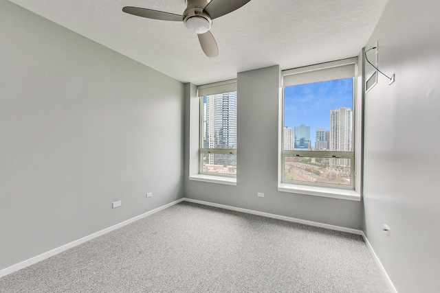 600 N Kingsbury St Unit 1612, Chicago, IL 60654 - carpeted empty room with a view of city, baseboards, and a ceiling fan