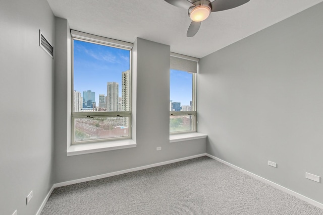 600 N Kingsbury St Unit 1612, Chicago, IL 60654 - carpeted empty room with visible vents, a ceiling fan, a city view, and baseboards