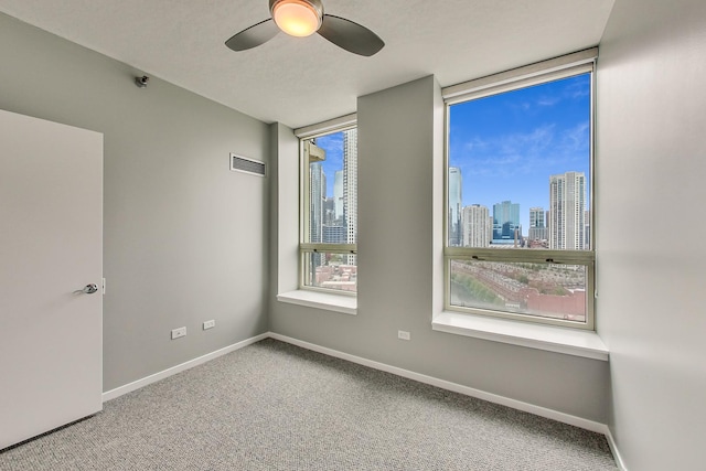 600 N Kingsbury St Unit 1612, Chicago, IL 60654 - empty room with visible vents, a ceiling fan, a city view, and carpet flooring