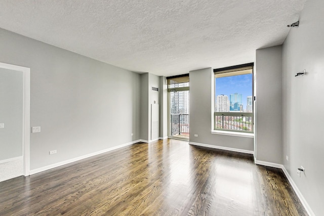 600 N Kingsbury St Unit 1612, Chicago, IL 60654 - unfurnished room featuring dark wood finished floors, baseboards, and a textured ceiling