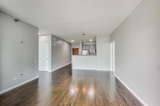 600 N Kingsbury St Unit 1612, Chicago, IL 60654 - unfurnished living room featuring recessed lighting, a textured ceiling, baseboards, and dark wood finished floors