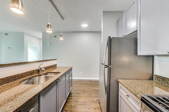 600 N Kingsbury St Unit 1612, Chicago, IL 60654 - kitchen with light stone countertops, wood finished floors, decorative light fixtures, and a sink