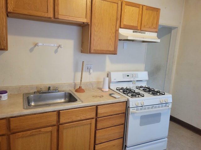 326 156th Pl, Calumet City, IL 60409 - kitchen with light countertops, under cabinet range hood, a sink, and gas range gas stove