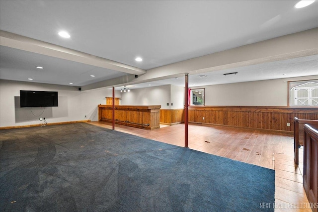 317 Plymouth Ct, Sycamore, IL 60178 - basement featuring wood-type flooring, wainscoting, bar, wood walls, and recessed lighting