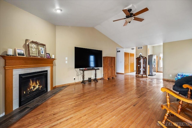 317 Plymouth Ct, Sycamore, IL 60178 - living room featuring ceiling fan, a fireplace, wood finished floors, vaulted ceiling, and baseboards