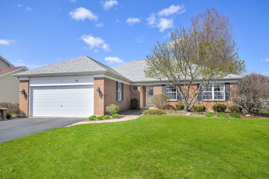 27 Raven Dr, Aurora, IL 60506 - ranch-style home featuring brick siding, aphalt driveway, a front yard, and a garage