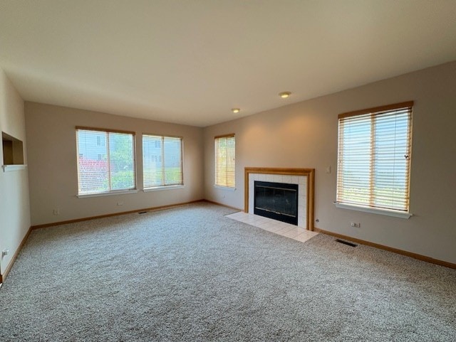 794 Meadowridge Dr, Aurora, IL 60504 - unfurnished living room featuring a tile fireplace and carpet flooring