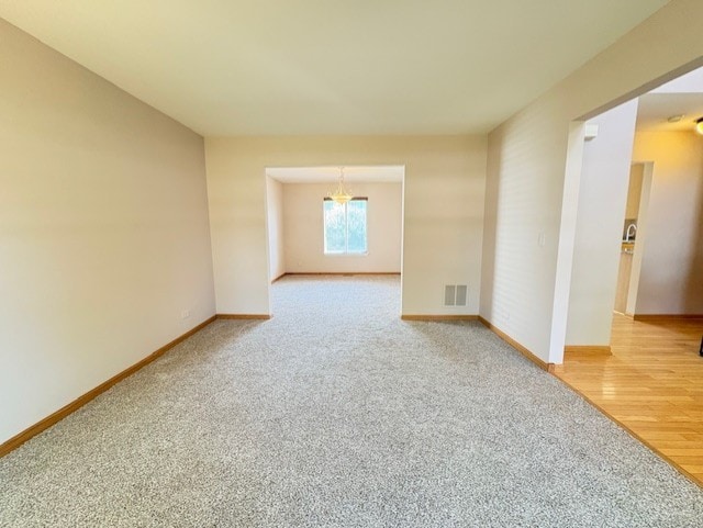 794 Meadowridge Dr, Aurora, IL 60504 - unfurnished room featuring a chandelier and light colored carpet