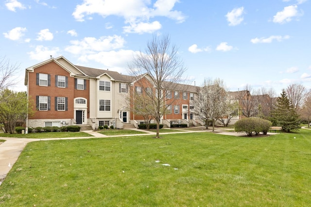 view of home's community featuring entry steps and a yard