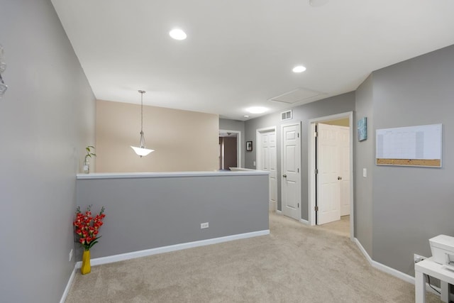 empty room featuring light colored carpet, visible vents, recessed lighting, and baseboards