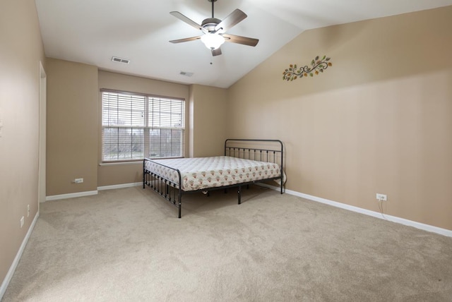 carpeted bedroom with visible vents, a ceiling fan, vaulted ceiling, and baseboards