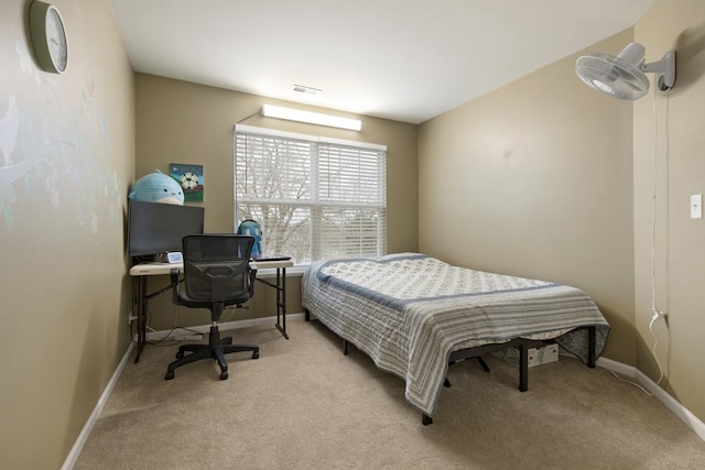 bedroom with baseboards, visible vents, and light carpet