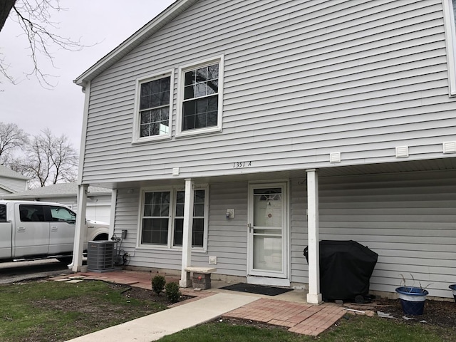 1351 N Glen Cir Unit A, Aurora, IL 60506 - view of front of property with cooling unit and covered porch