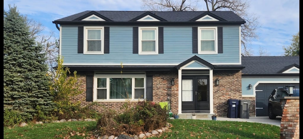 35 Devonshire Cir, Elgin, IL 60123 - view of front of home with an attached garage and brick siding