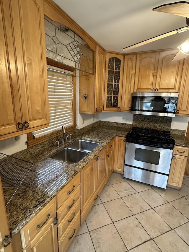 8817 S Constance Ave, Chicago, IL 60617 - kitchen with a ceiling fan, a sink, glass insert cabinets, stainless steel appliances, and light tile patterned flooring