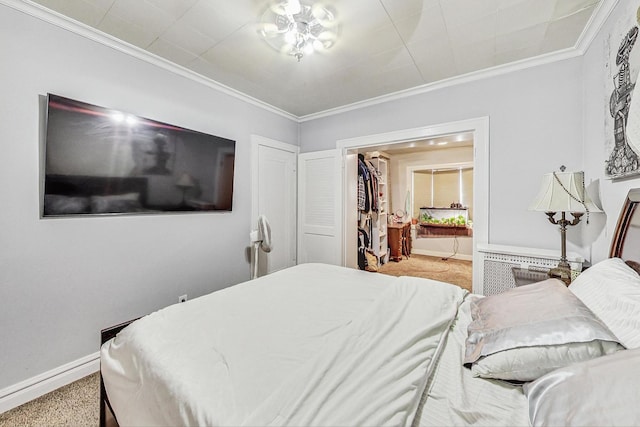 bedroom featuring ornamental molding, baseboards, carpet flooring, and ensuite bathroom