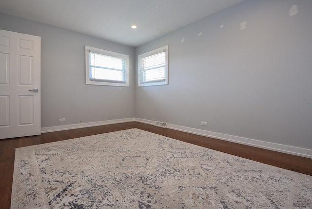 spare room with visible vents, recessed lighting, baseboards, and dark wood-style floors