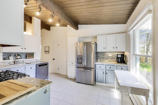 537 County Line Rd, Highland Park, IL 60035 - kitchen with appliances with stainless steel finishes, a sink, wood ceiling, light tile patterned flooring, and white cabinetry