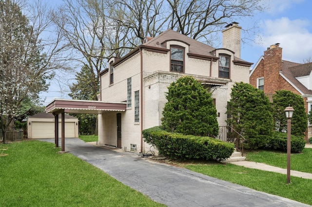 french country style house featuring brick siding, an outbuilding, a chimney, and a front lawn