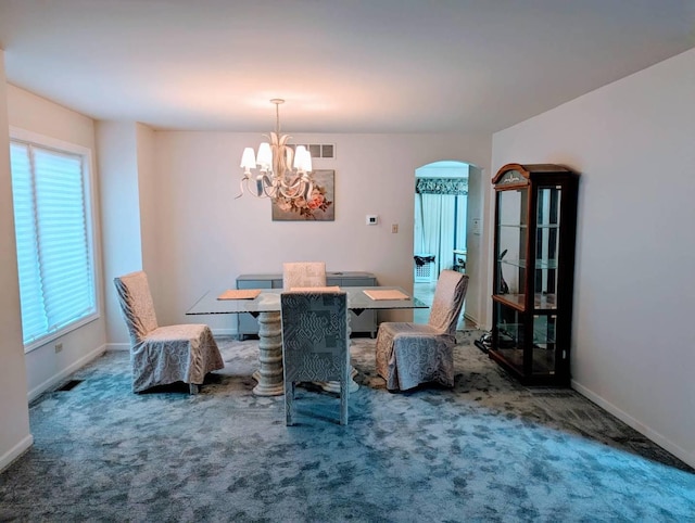 18507 Indie Ct, Hazel Crest, IL 60429 - dining room with arched walkways, carpet flooring, a chandelier, and baseboards