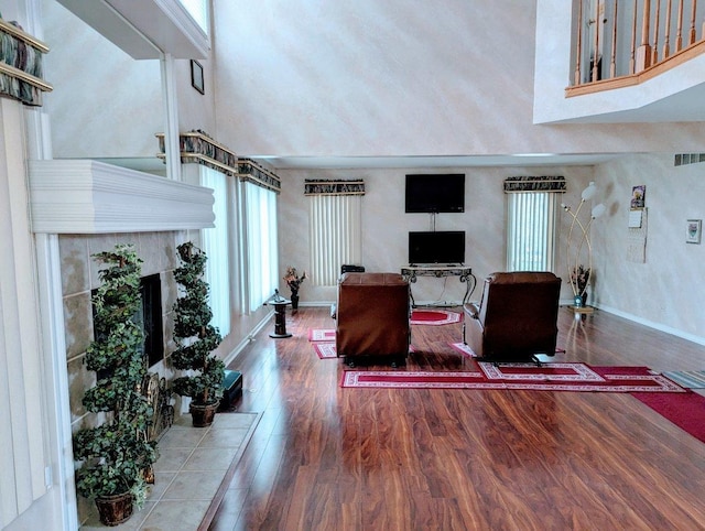 18507 Indie Ct, Hazel Crest, IL 60429 - living room featuring plenty of natural light, wood finished floors, a tile fireplace, and baseboards