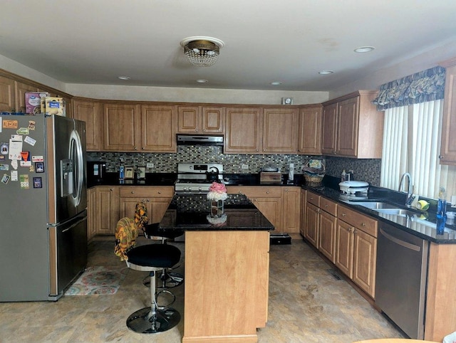 18507 Indie Ct, Hazel Crest, IL 60429 - kitchen with appliances with stainless steel finishes, under cabinet range hood, a sink, a kitchen island, and a breakfast bar area