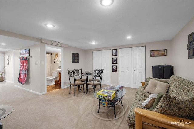 living area with baseboards, recessed lighting, and light colored carpet