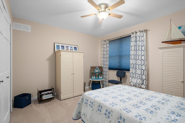 carpeted bedroom featuring visible vents, baseboards, and ceiling fan