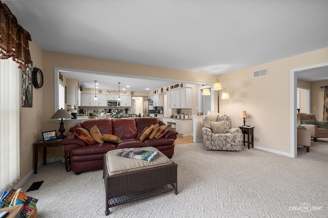 living room featuring light carpet, baseboards, and visible vents