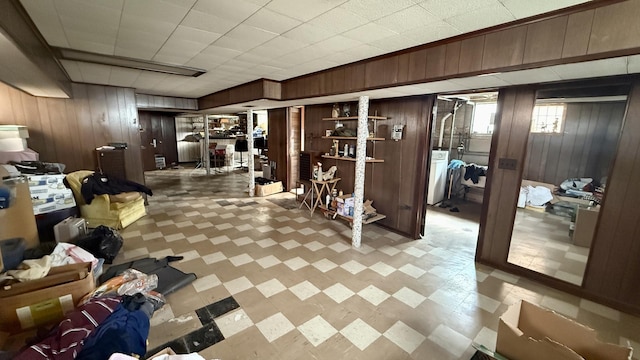12450 S Yale Ave, Chicago, IL 60628 - basement with tile patterned floors, wood walls, and washer / dryer