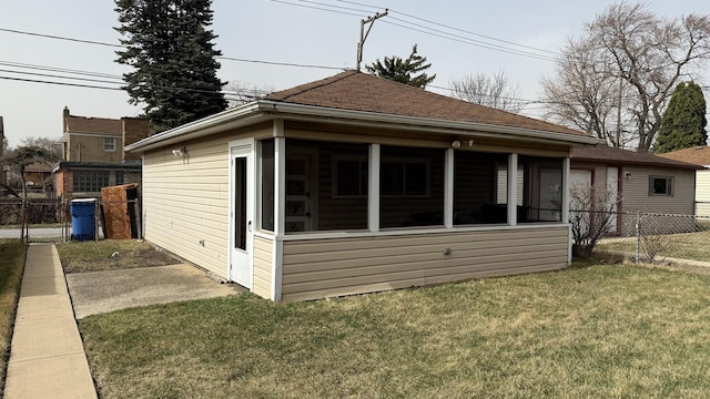 12450 S Yale Ave, Chicago, IL 60628 - back of property featuring a sunroom, a yard, and fence
