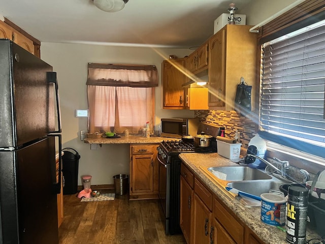 14701 E Riverside Dr, South Holland, IL 60473 - kitchen featuring freestanding refrigerator, stainless steel microwave, range with gas stovetop, dark wood-style floors, and brown cabinetry